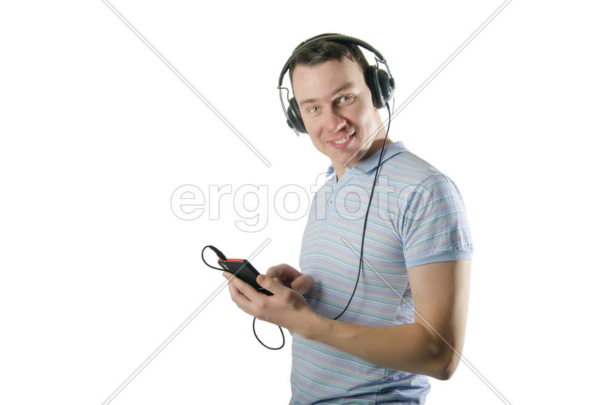 Smiling young man in headphones with a mobile phone on a white background