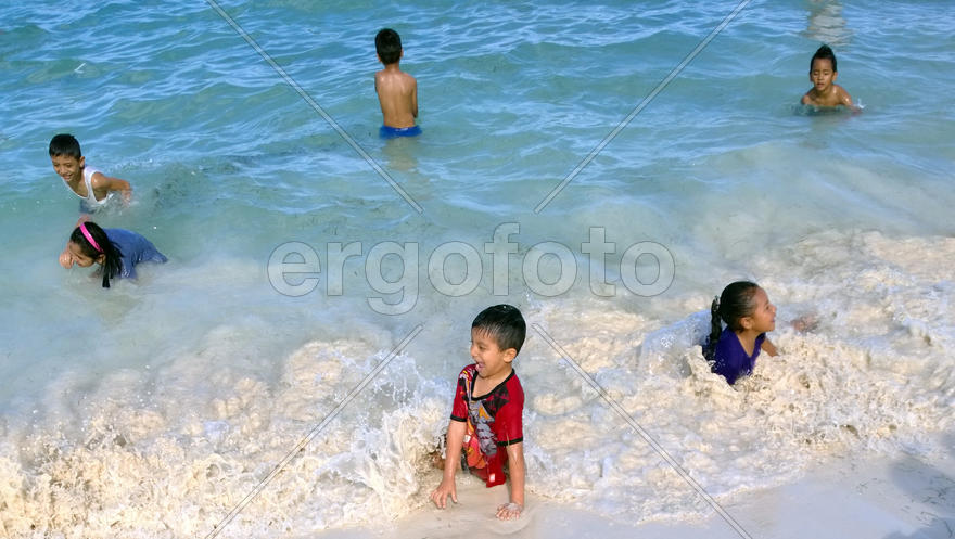 Children on the beach in Cancun, Mexico