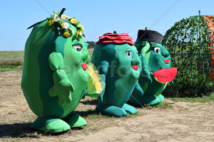 Large toy watermelon farmer before trading platform. Sale of the crop