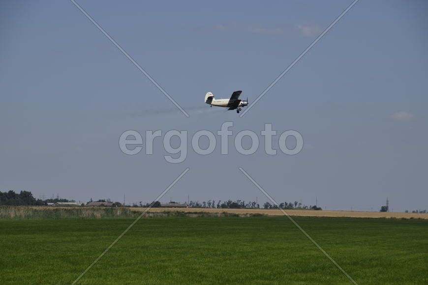 Aircraft agricultural aviation AN-2. The spraying of fertilizers and pesticides on the field with th