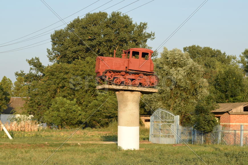 Russia, Temryuk - 15 July 2015: Tractor on a pedestal. Monument agricultural machinery.