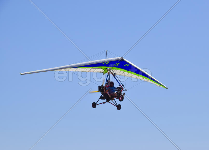Russia, Veselovka - September 6, 2016: Trike, flying in the sky with two people. Extreme Entertainme