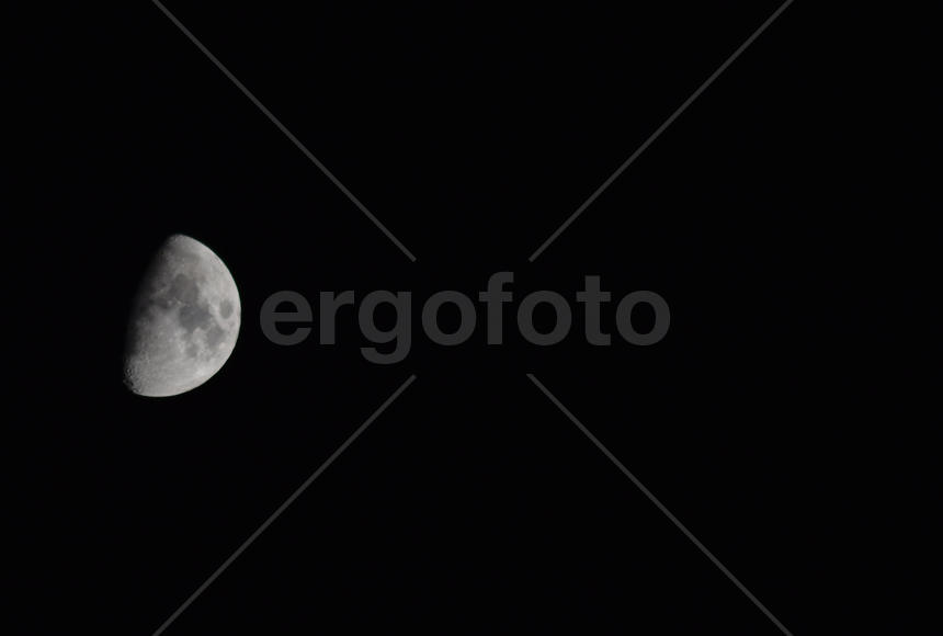 The moon in the night sky. Two thirds of the moon