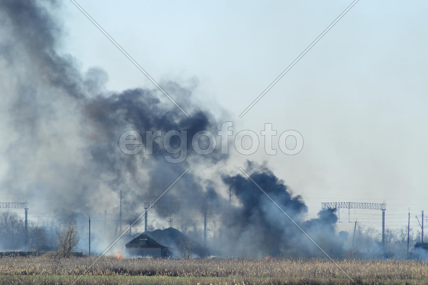 Fire on irrigation canals. Burning dry grass and cane fields in irrigation system. Burning debris