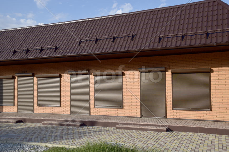 The roof of corrugated sheet on a building. Brown roofing metal sheets on Rented store. 