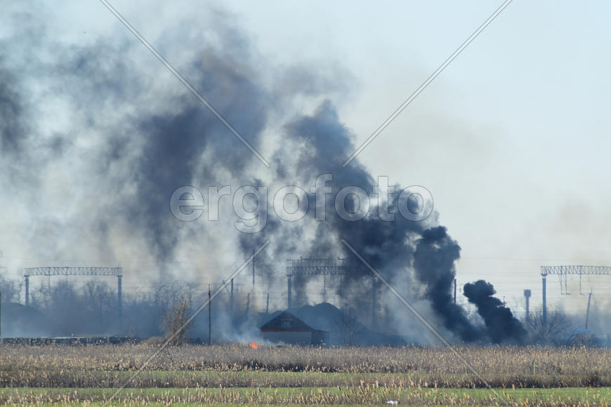 Fire on irrigation canals. Burning dry grass and cane fields in irrigation system. Burning debris