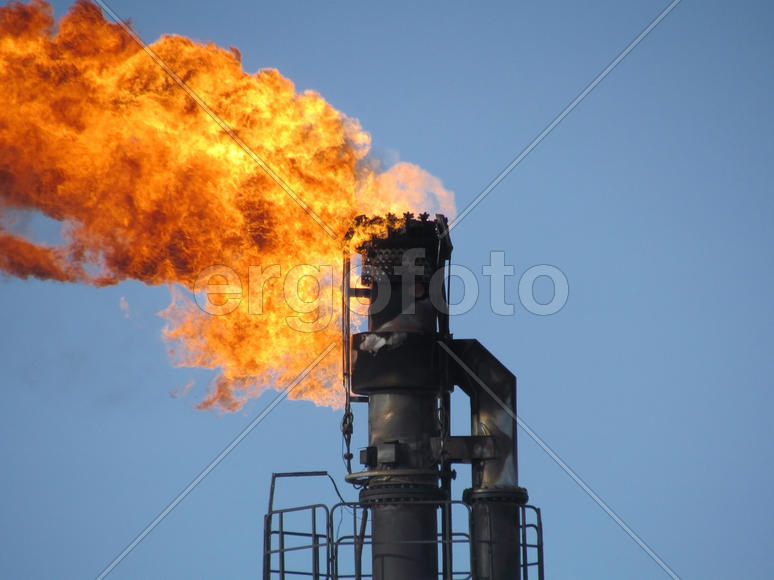 System of a torch on an oil field. Burning through a torch head