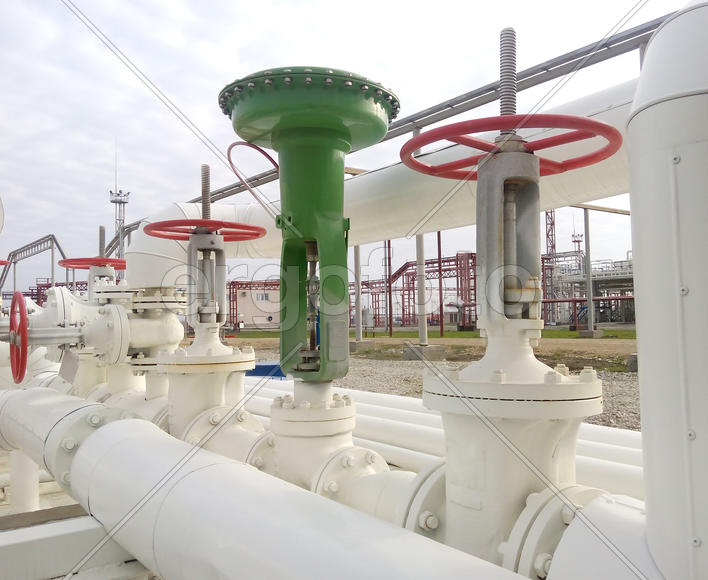 Green pneumatic valve on the pipeline. The equipment of the oil plant                             