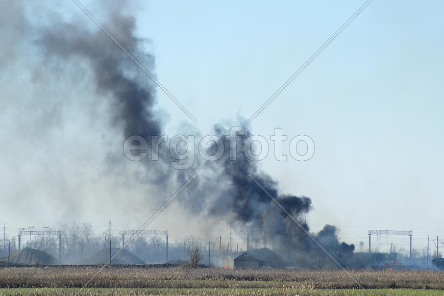 Fire on irrigation canals. Burning dry grass and cane fields in irrigation system. Burning debris