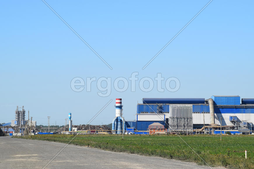 Access road to the Big plant for processing scrap metal. Huge factory old metal refiner. Blue roof