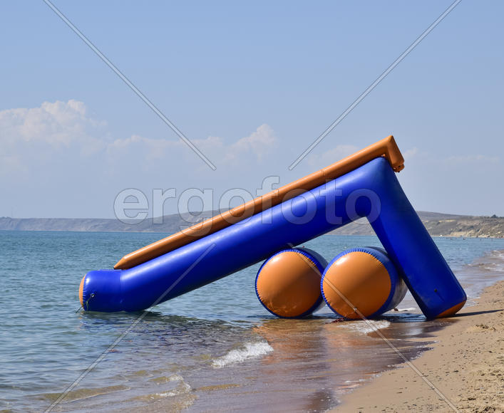 Inflatable slide to slide into the water. Children's attraction.
