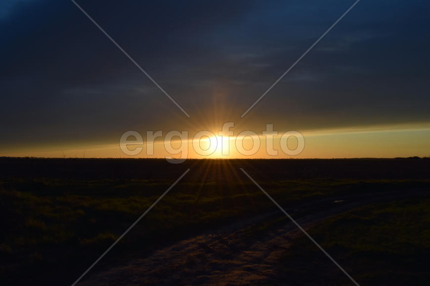 Sunset on a background field. Landscape view in the evening at sunset