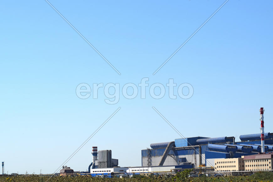Big plant for processing scrap metal. Huge factory old metal refiner. Blue roof of the factory build