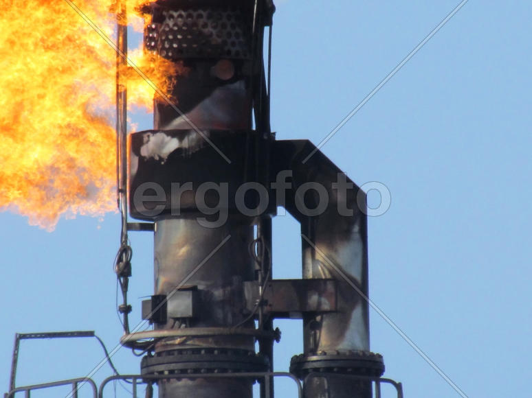 System of a torch on an oil field. Burning through a torch head