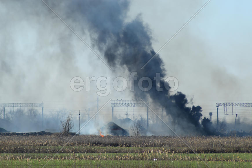 Fire on irrigation canals. Burning dry grass and cane fields in irrigation system. Burning debris