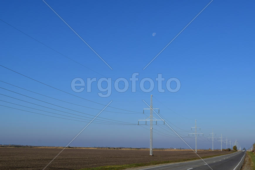 Support of electricity cables along the road. Country road