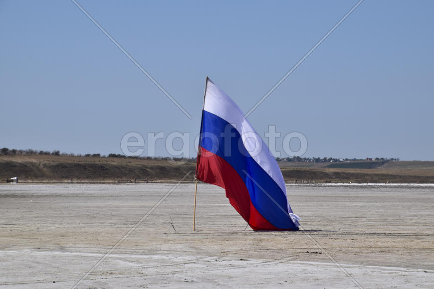 Russian flag on the bottom of a salty lake. Attributes country.