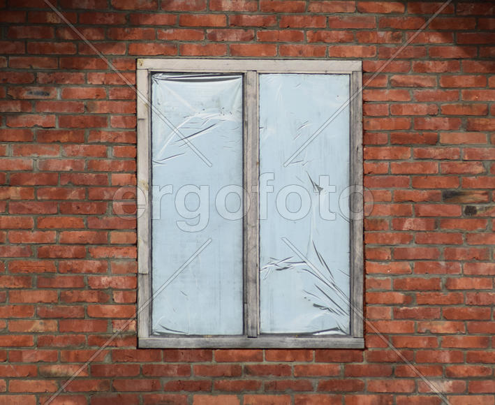 Window in a brick wall. Construction of the house