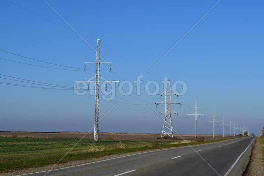 Support of electricity cables along the road. Country road