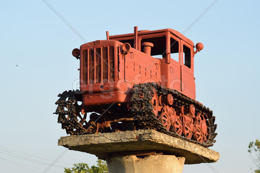 Russia, Temryuk - 15 July 2015: Tractor on a pedestal. Monument agricultural machinery.
