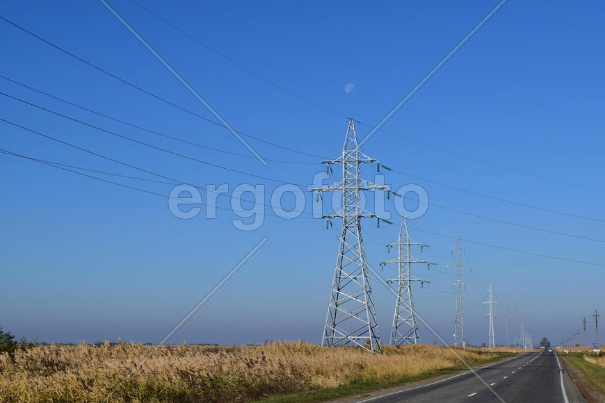 Support of electricity cables along the road. Country road