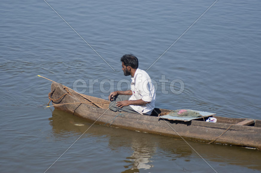 Fisherman fishes on the lake in the old Goa