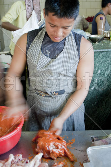 Сook prepares chicken in the kitchen of the restaurant street in the Indian city of Pune