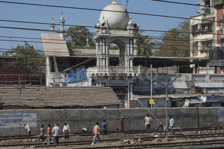 Workers on railroad tracks in Mumbai