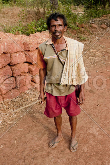 Rustic shepherd in red shorts with a stick