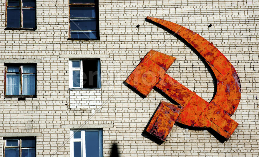 Hammer and sickle on the brick wall