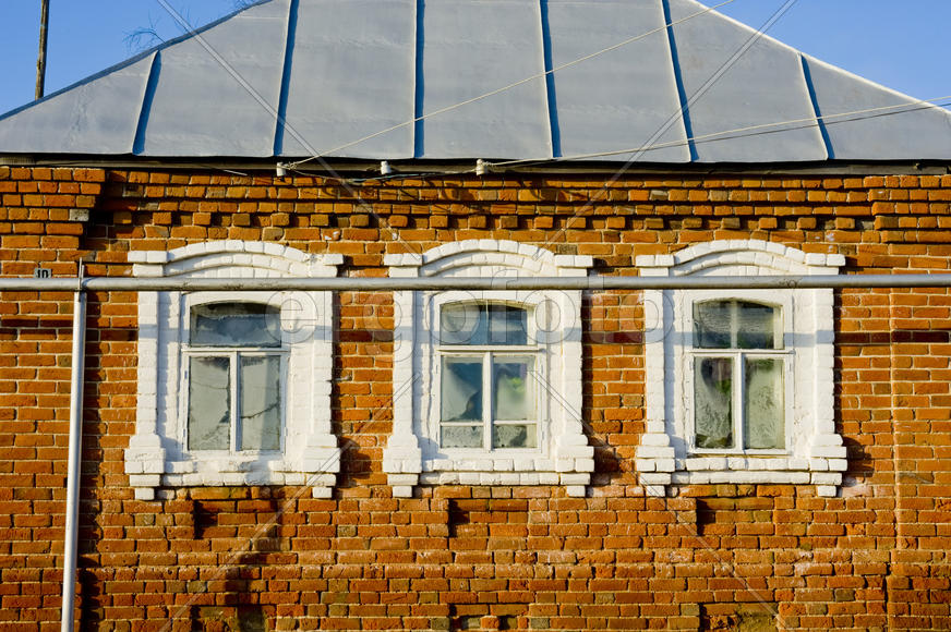Brick apartment farmhouse with three sunlit windows