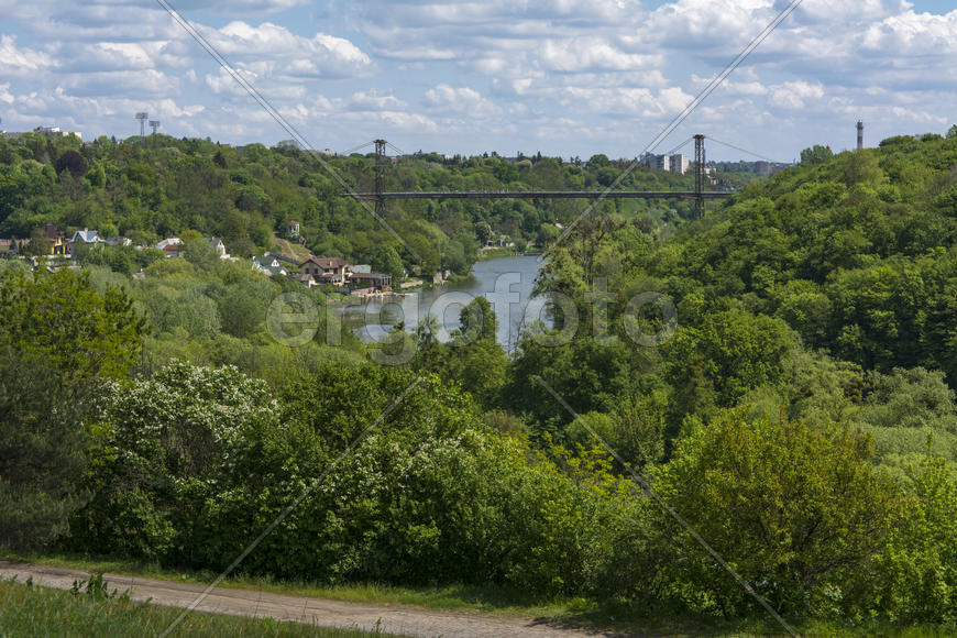 Suspension bridge across the river in city park