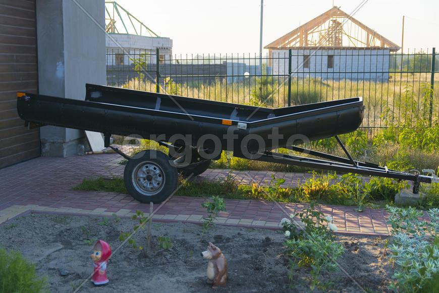 Trailers for inflatable boats in the yard of a private house