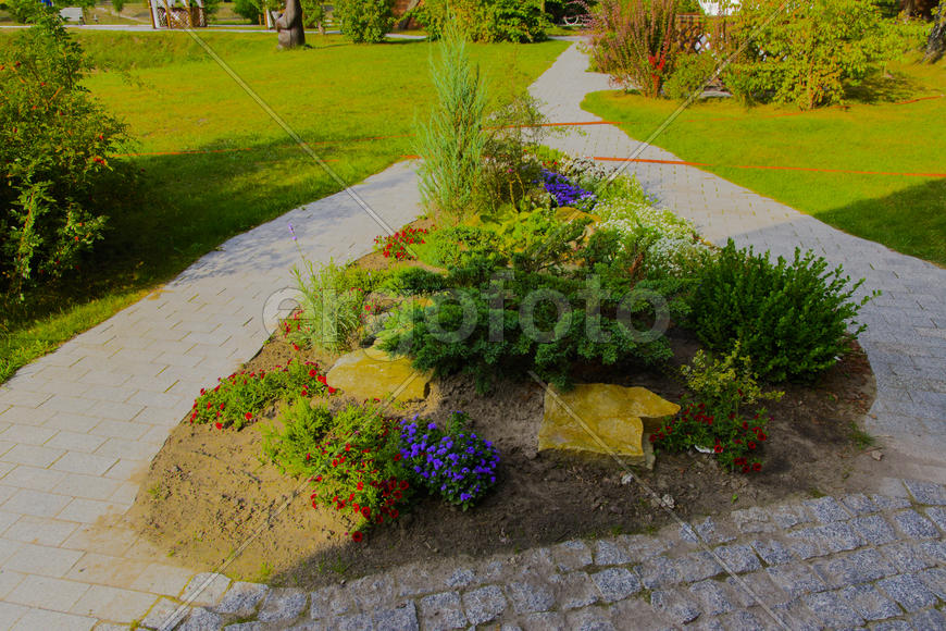 Flower beds, surrounded by gardens and an alley near the house