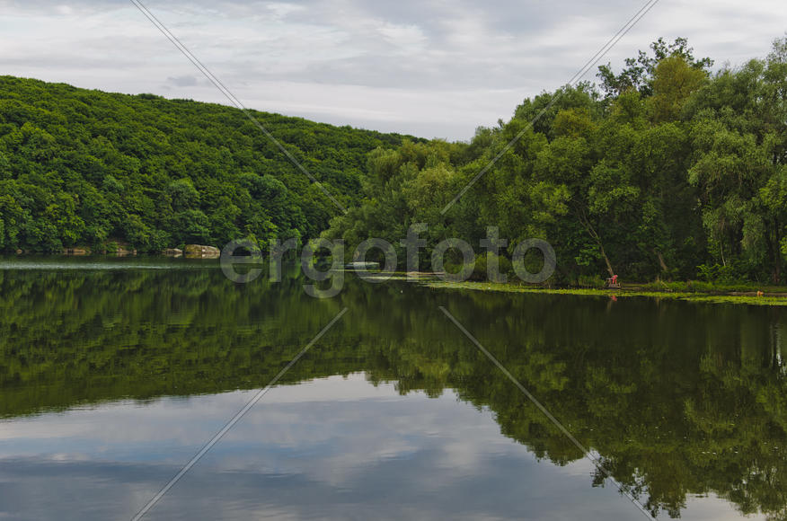 Reflection of two coast in the river the Southern Bug. Ukraine