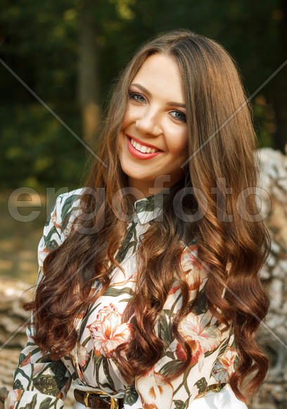 Portrait of happy brunette girl poses on nature outdoors