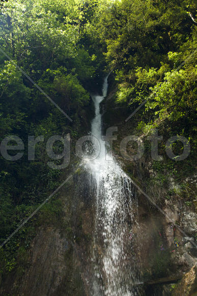 The falls in mountains flow from above and rustle