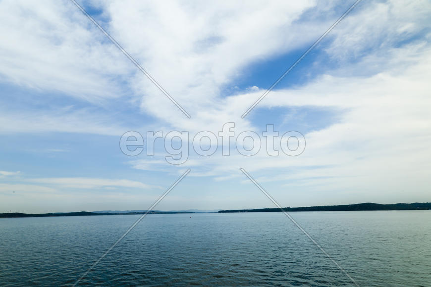 Sea landscape in cloudy day at a full calm