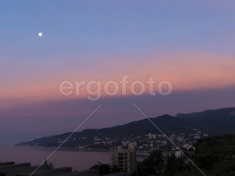 Mountains by the sea in beams of a bright sun