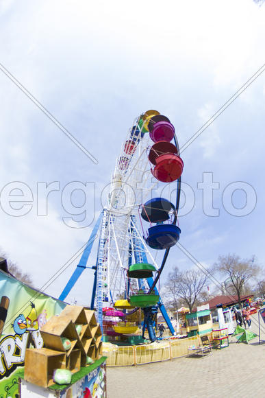 The big wheel in park pleases children and waits for them for driving
