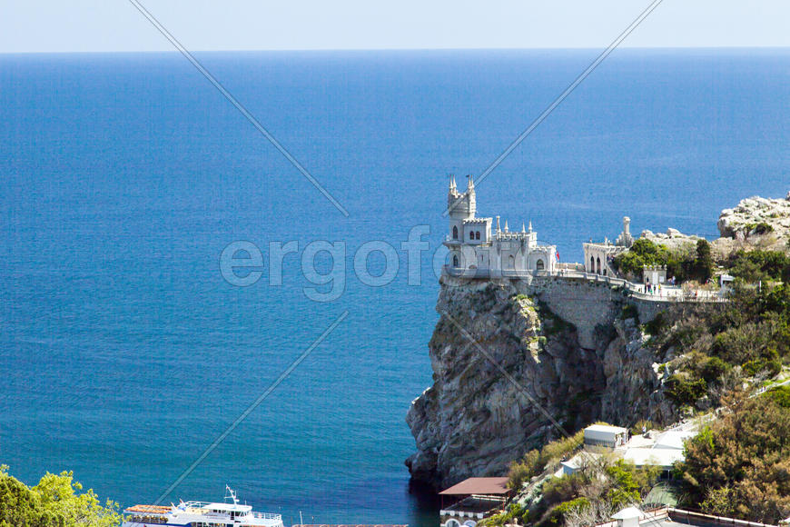 The castle by the sea is on the rock highly above water