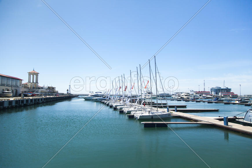 Boats and yachts stand at a quay in port