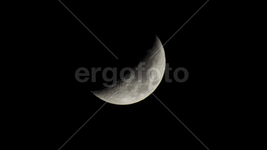 The bright crescent moon hangs over Earth all the time