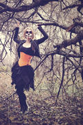 Девушка в маскарадном костюме у дерева