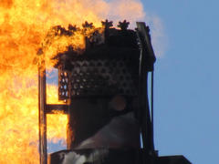 System of a torch on an oil field. Burning through a torch head