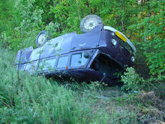 The car which moved down in a ditch as a result of accident. The turned car
