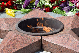 Eternal flame with flowers assigned to it. Celebration of May 9 Victory in the Great Patriotic War