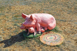 Декоративная фигурка свиньи с поросятами в саду 