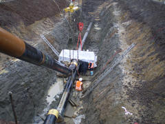 Sakhalin, Russia - 12 November 2014: Laying of the gas pipeline in a ditch. Installation works