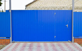 Blue gate and fence. Fence of the private house with blue fence and a gate.